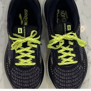 Black and green Brooks running shoes.